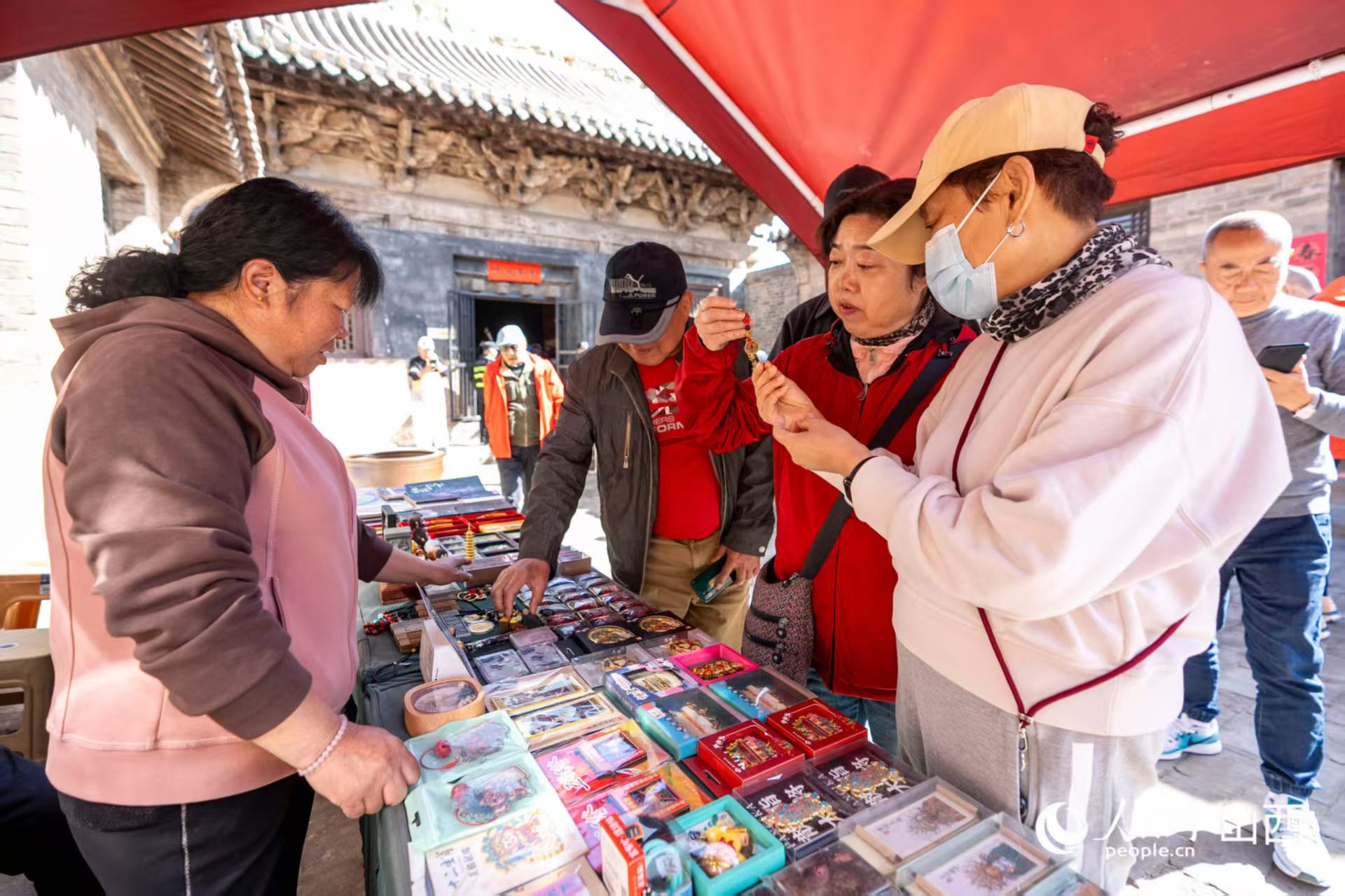 游客在山西省高平市鐵佛寺選購(gòu)文創(chuàng)產(chǎn)品。人民網(wǎng)記者 盧鵬宇攝